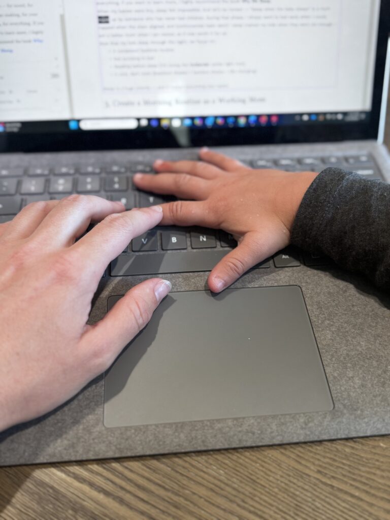 Working mom with child helping on the laptop